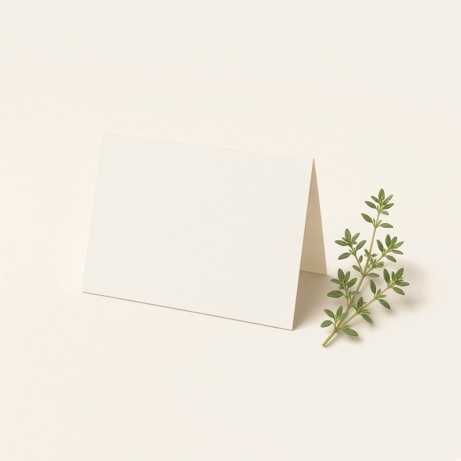 A blank folded card with a sprig of herbs