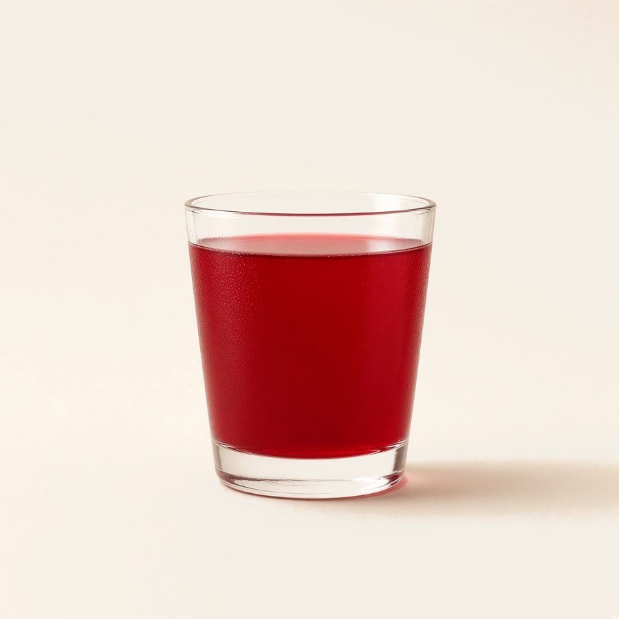A short glass of deep red drink